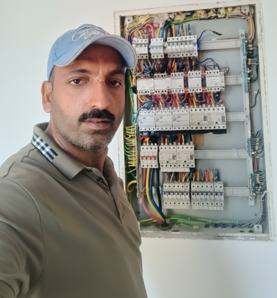 Electrical Service An expert electrician from Abu Taleb Technical Services performing DB dressing and panel wiring.